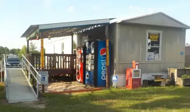 Small roadside store with ramp, vending machines, and a Pepsi sign.
