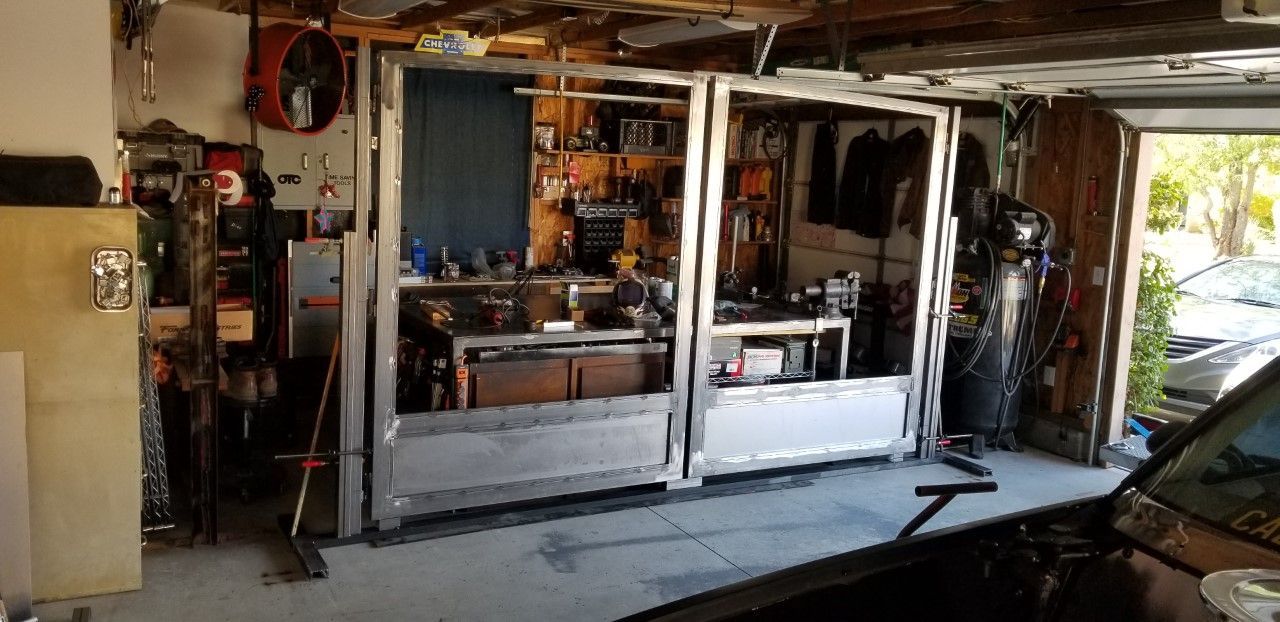 A garage filled with lots of tools and a car parked in front of it.