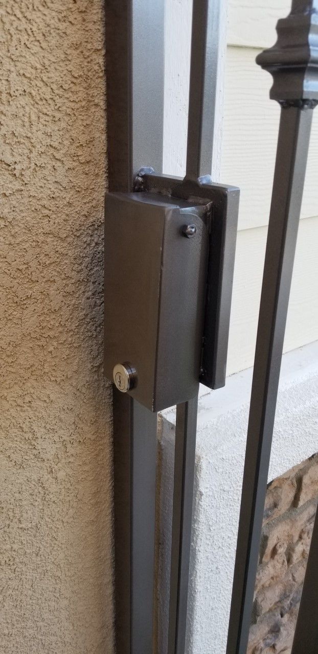 A close up of a metal gate with a lock on it.