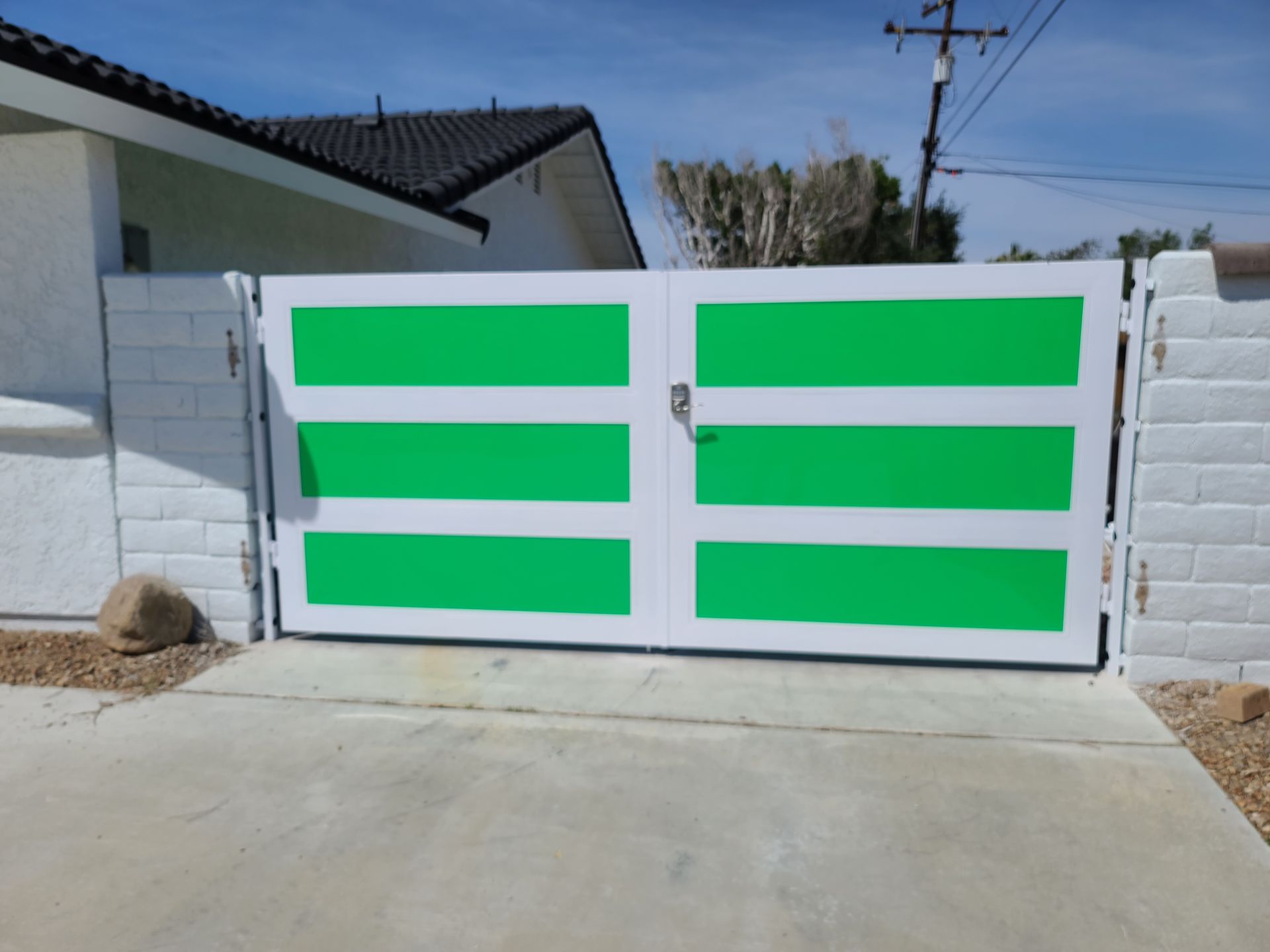 A white gate with green stripes on it