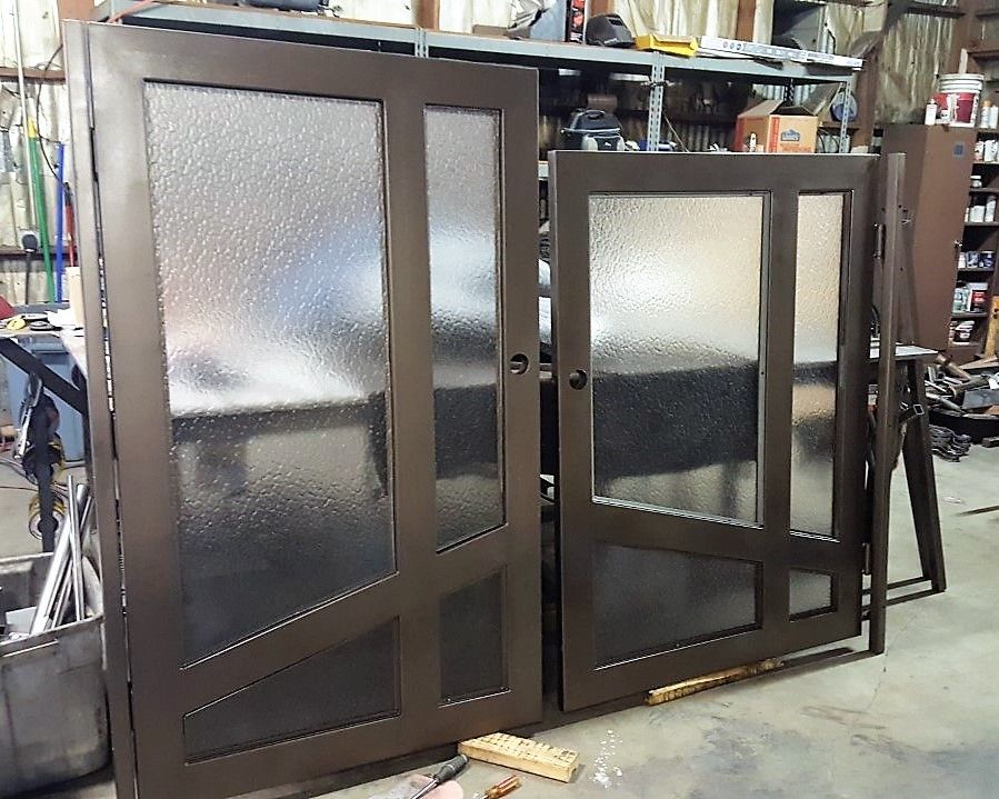 A pair of sliding glass doors are sitting on a concrete floor