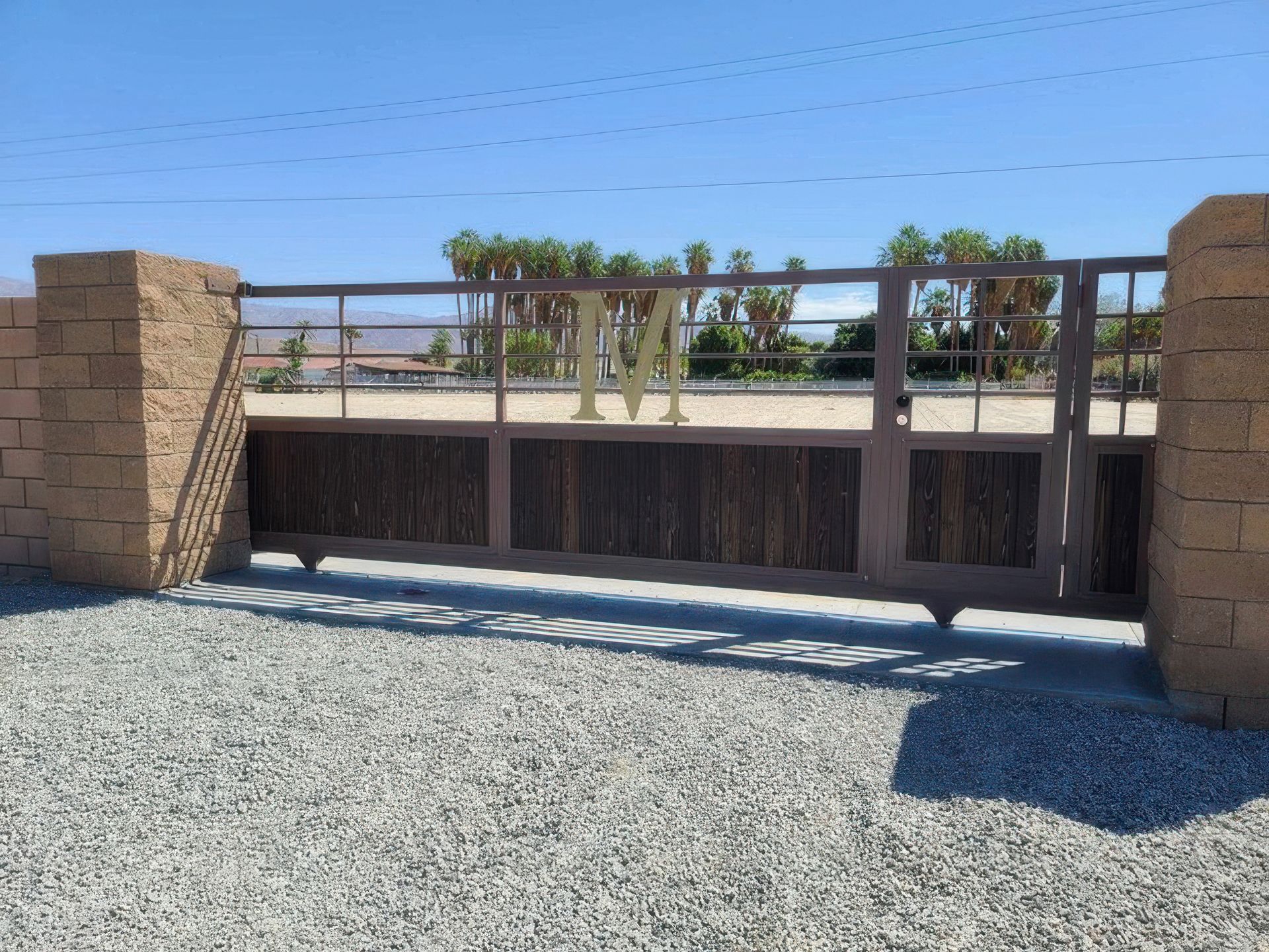 A sliding gate with a brick wall behind it
