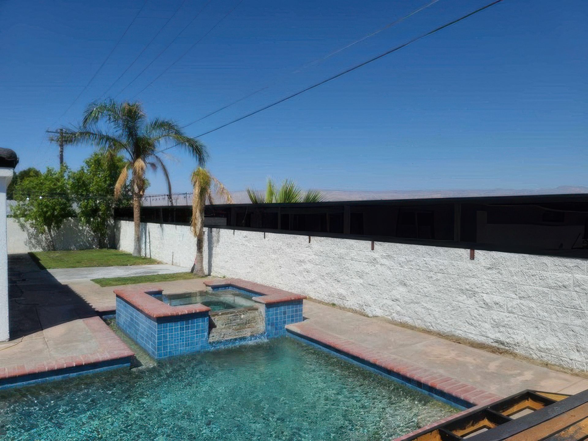 A swimming pool with a black fence surrounding it