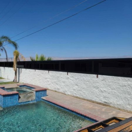A swimming pool with a black fence surrounding it