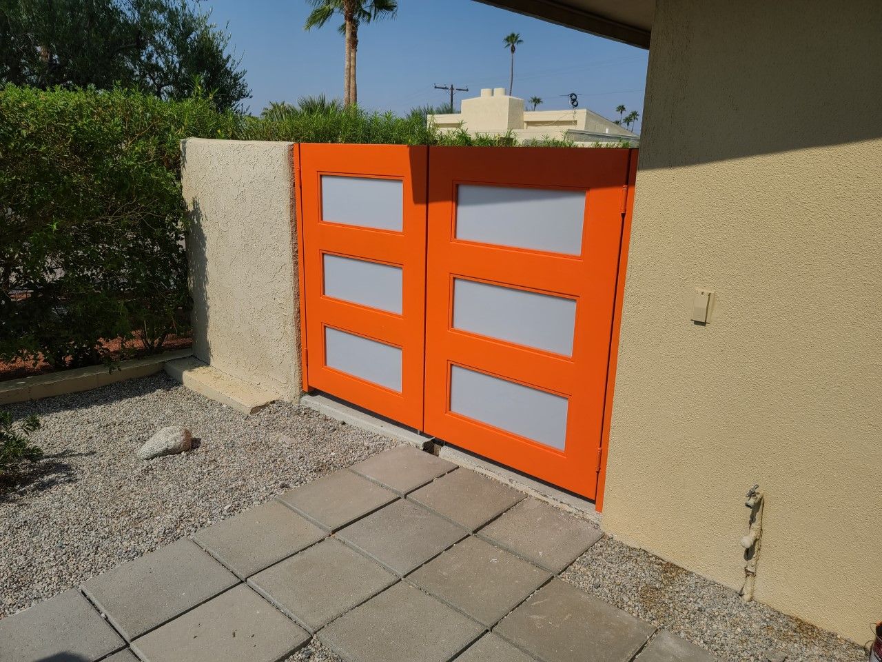 An orange gate with white stripes on it