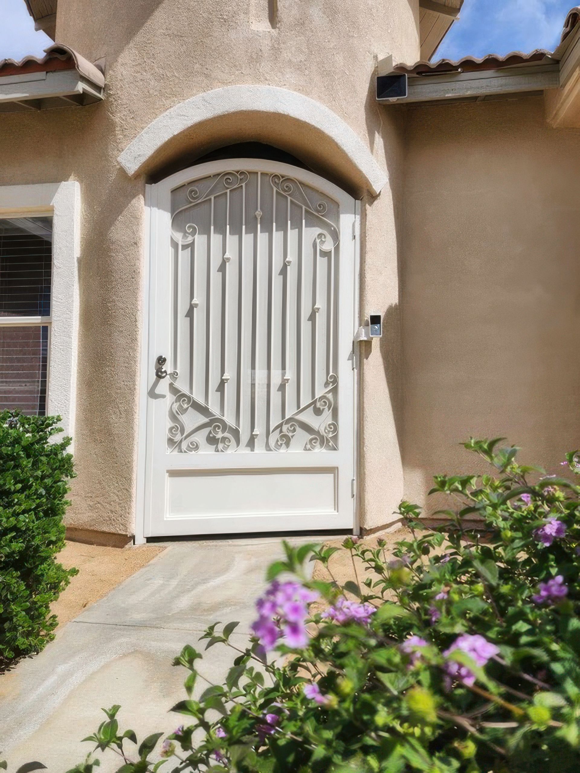 A white door with purple flowers in front of it
