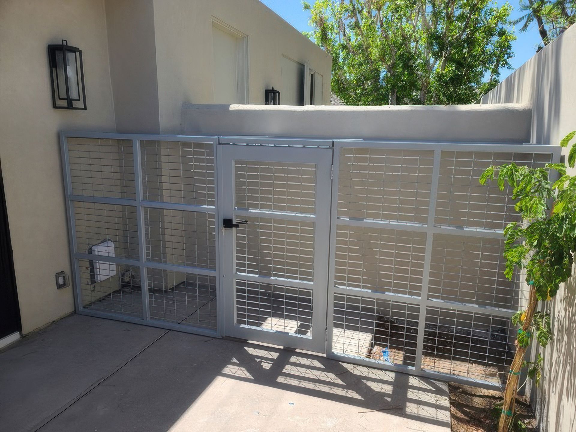 A fence with a gate in front of a building.