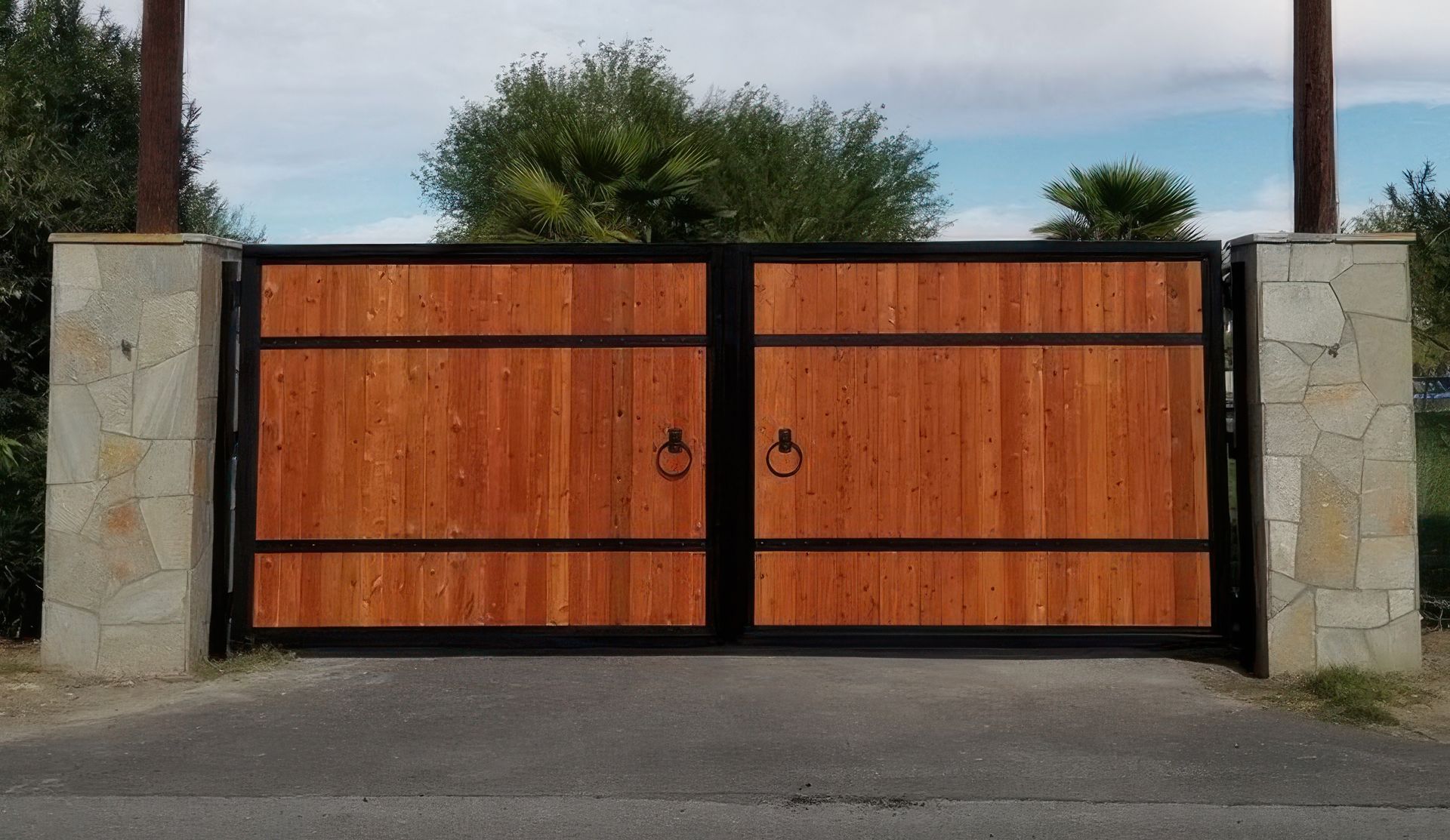A wooden gate is sitting on the side of a road.