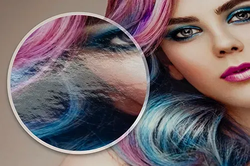 Close-up of a woman's face with vibrant, colorful hair printed on Fujicolor Pearl paper. A magnified section highlights the papers texture.