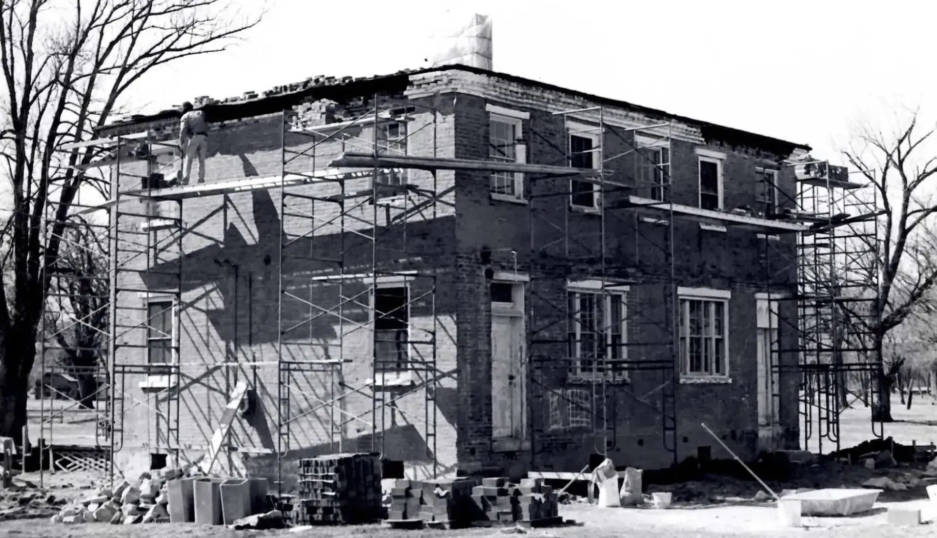 Building exterior with scaffolding during renovation, black and white.