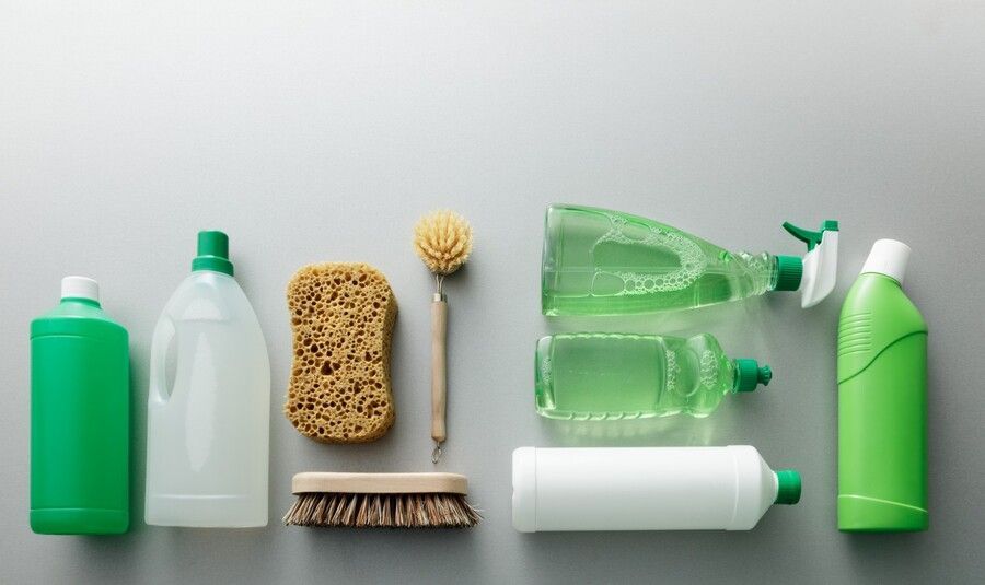 There are many different types of cleaning supplies on the table.