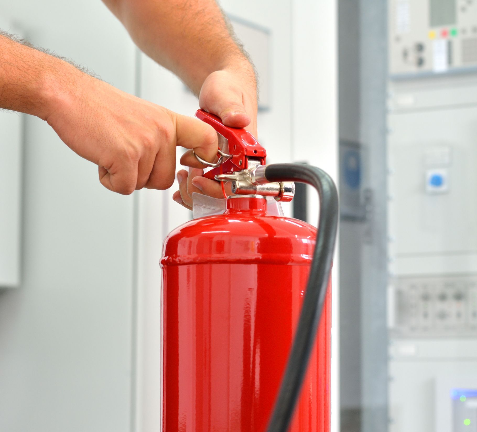 Worker demonstrates the use of fire extinguishers.