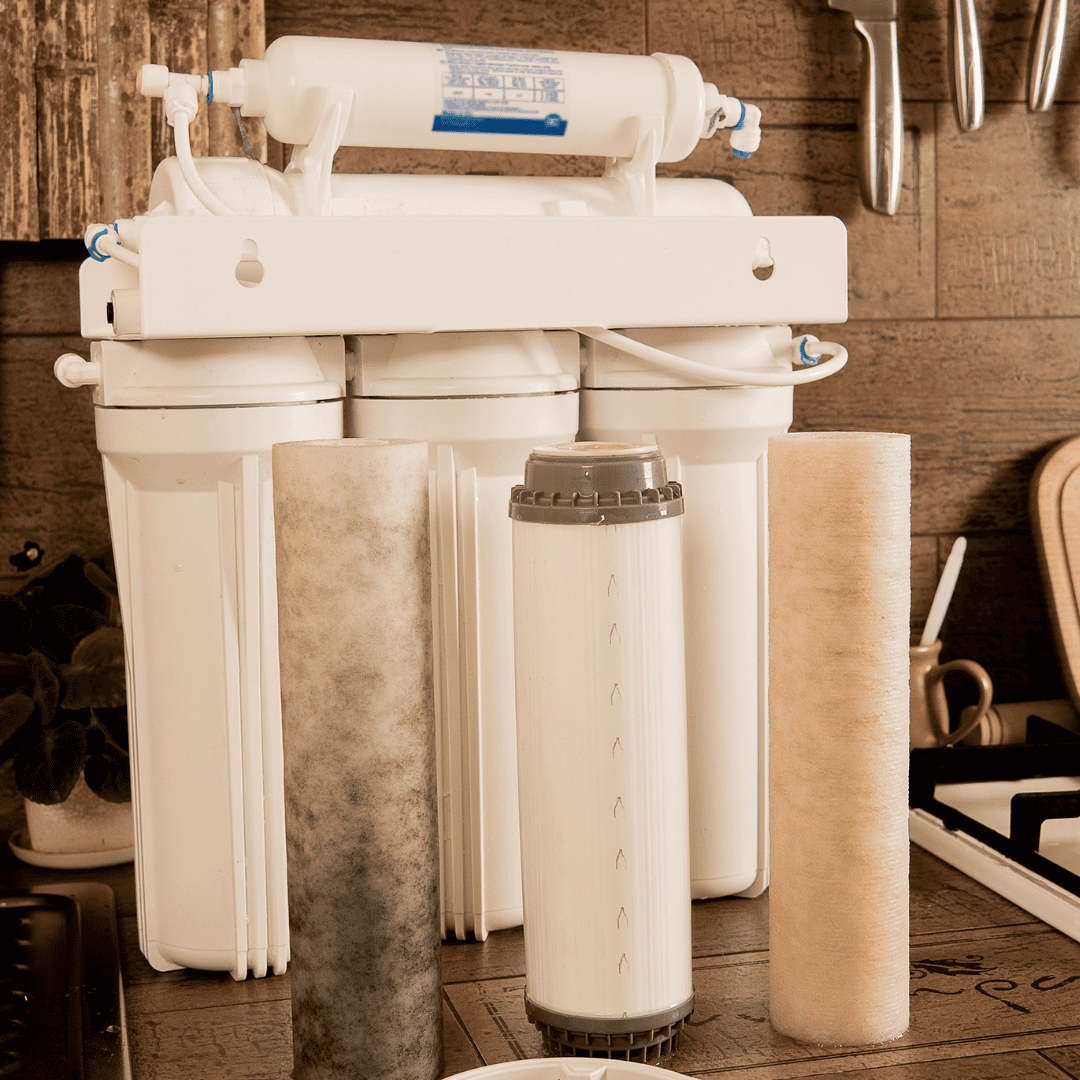 A 3-stage water filter showing all components on a counter 