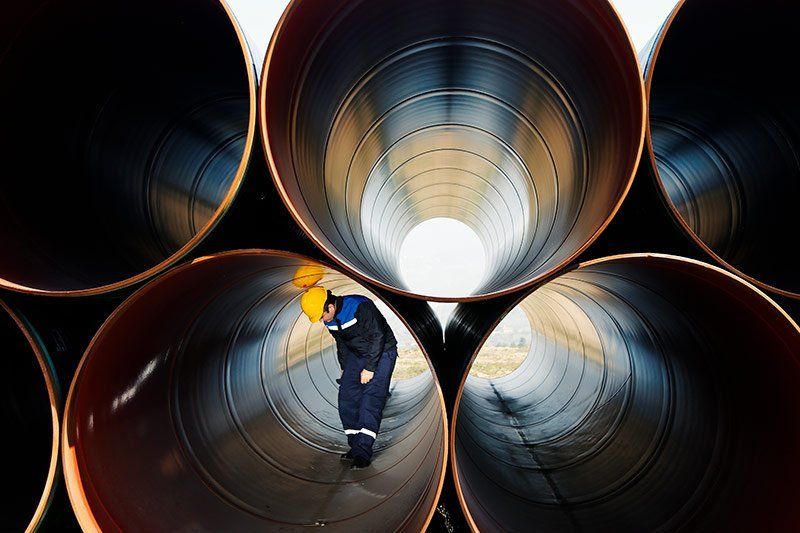 plumber standing in giant pipe