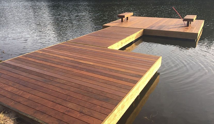 A wooden dock is in the middle of a lake.
