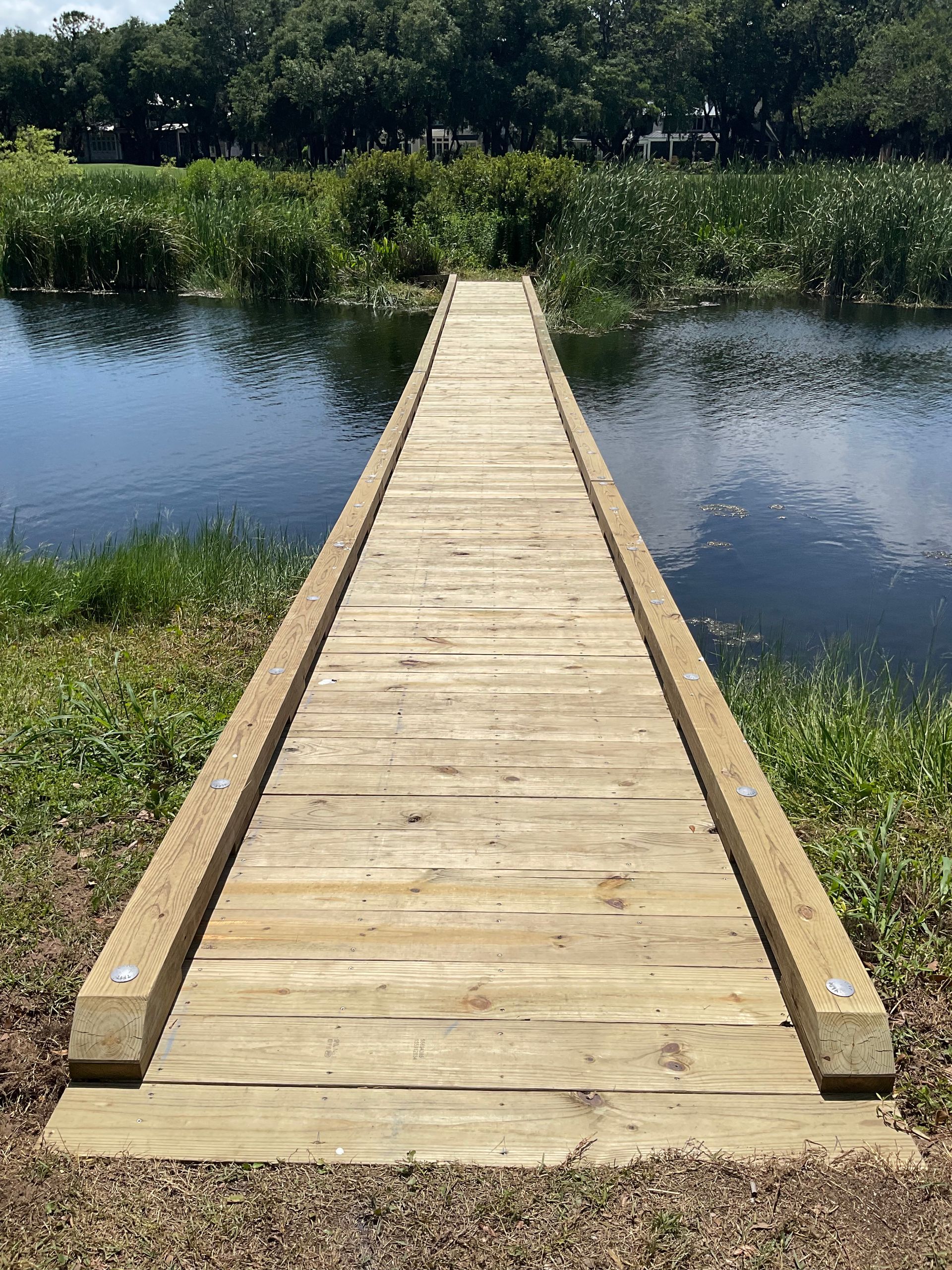 A wooden dock leading into a body of water.