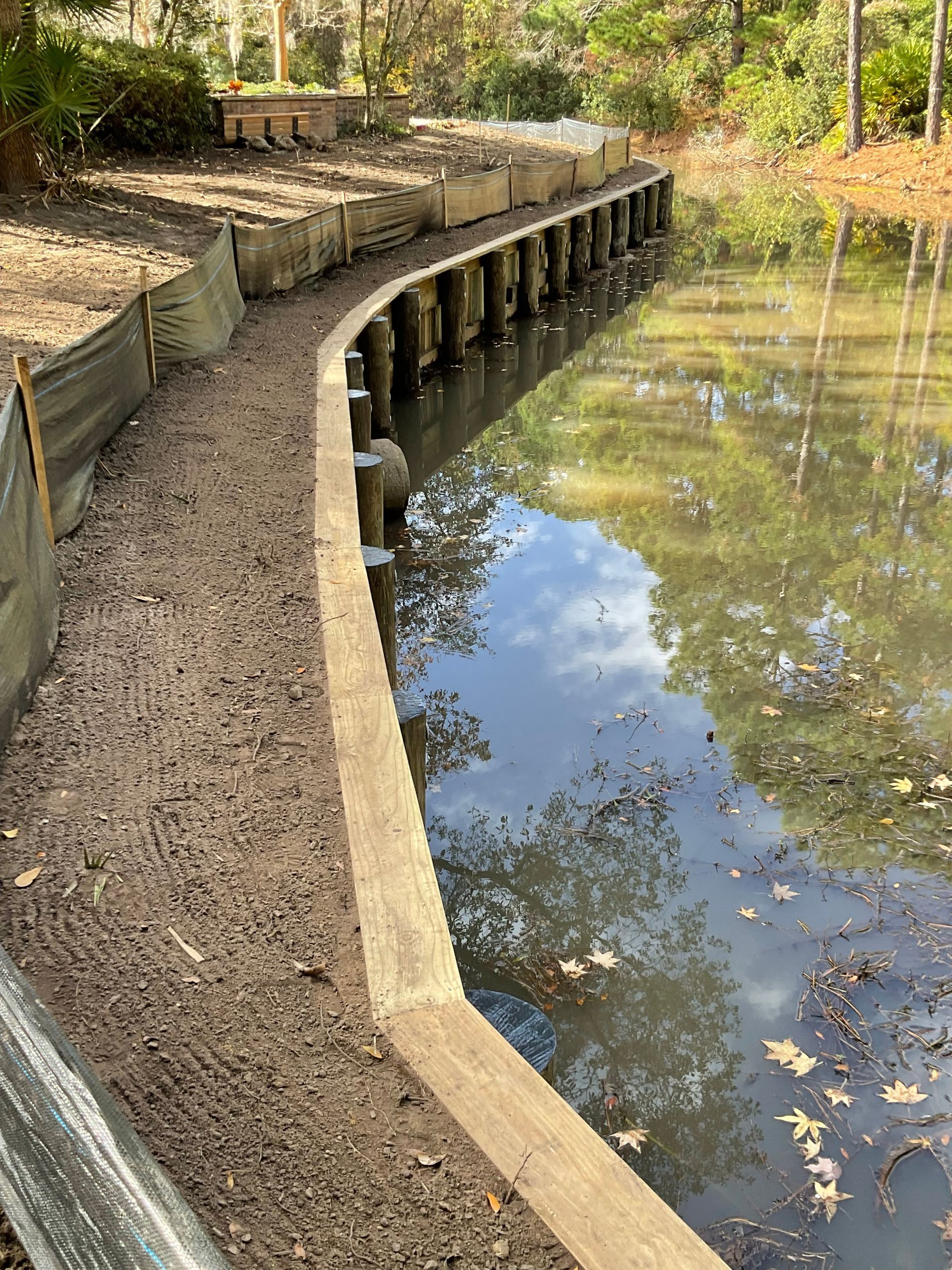 A large body of water with a concrete wall surrounding it