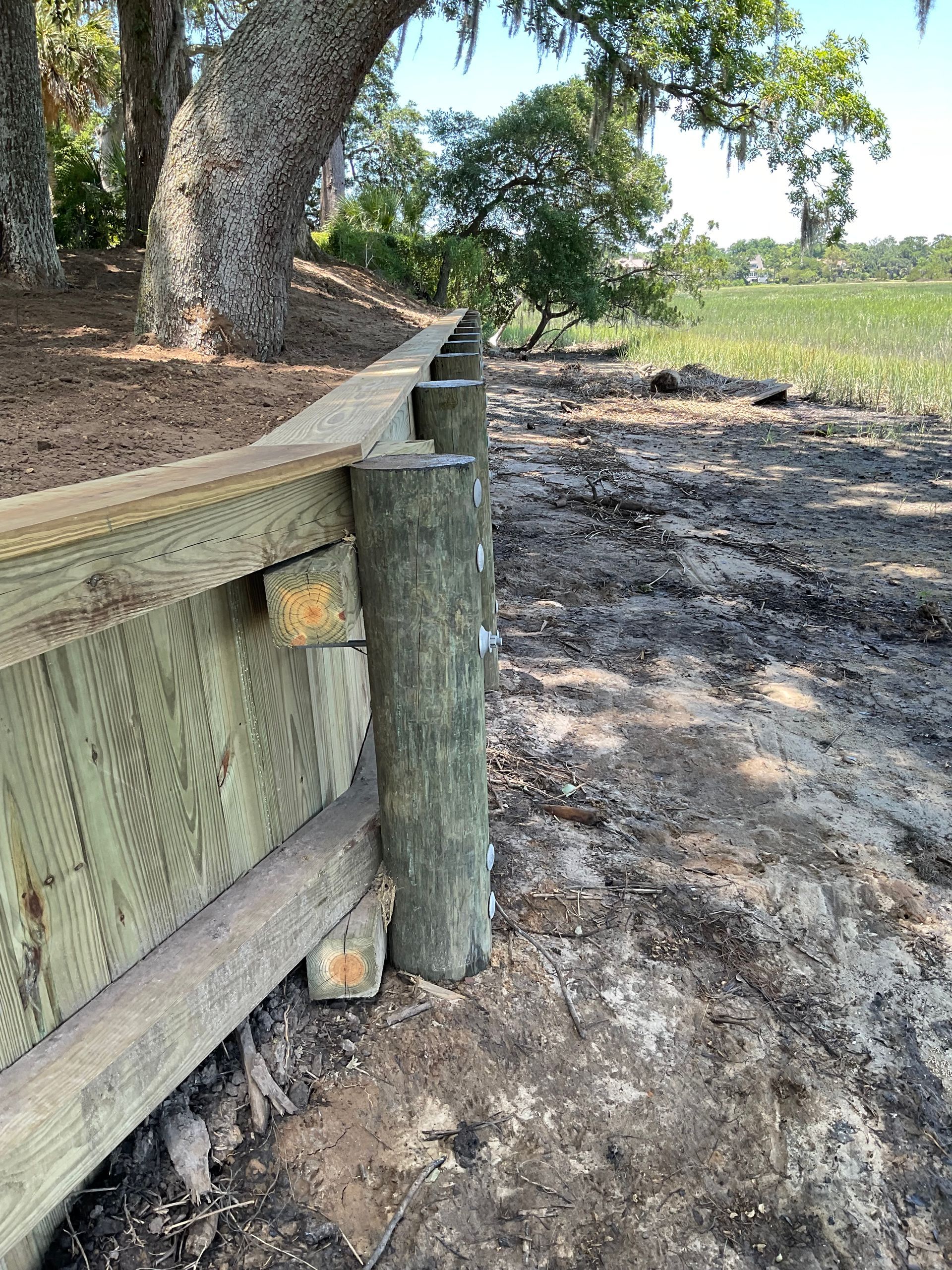 A wooden fence is being built next to a tree.