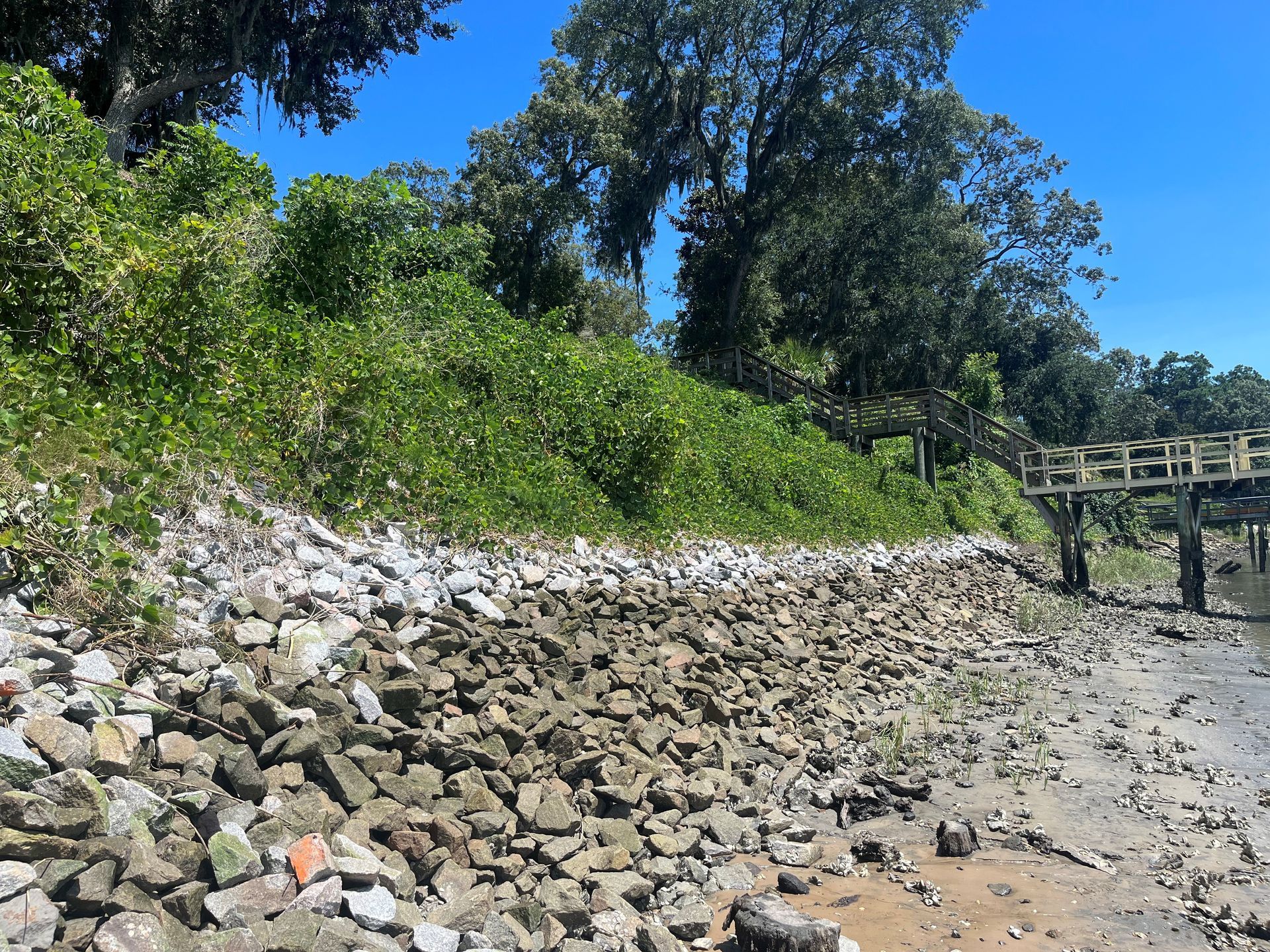 There is a bridge in the background and a lot of rocks in the foreground.