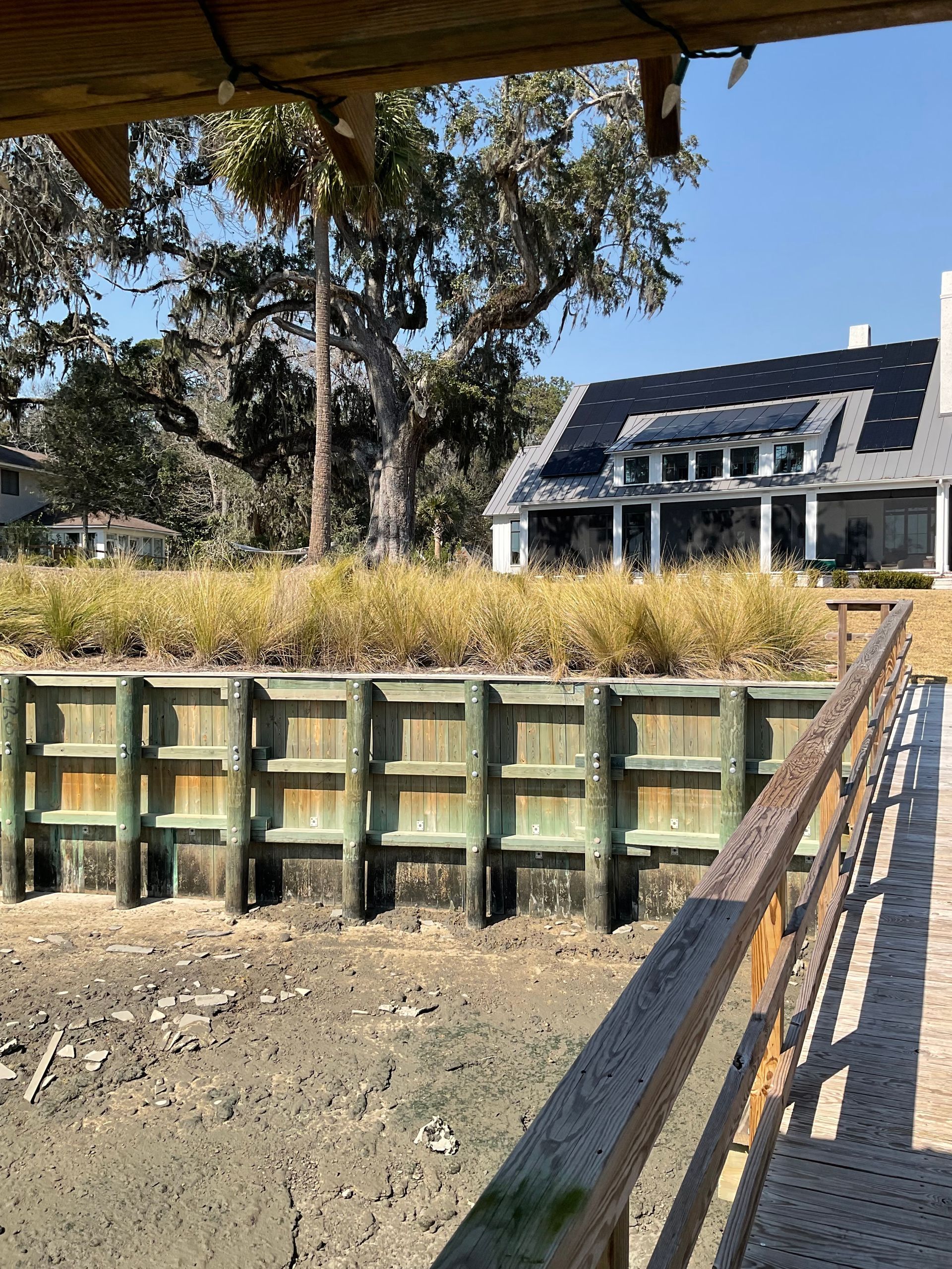 A view of a house from a wooden bridge