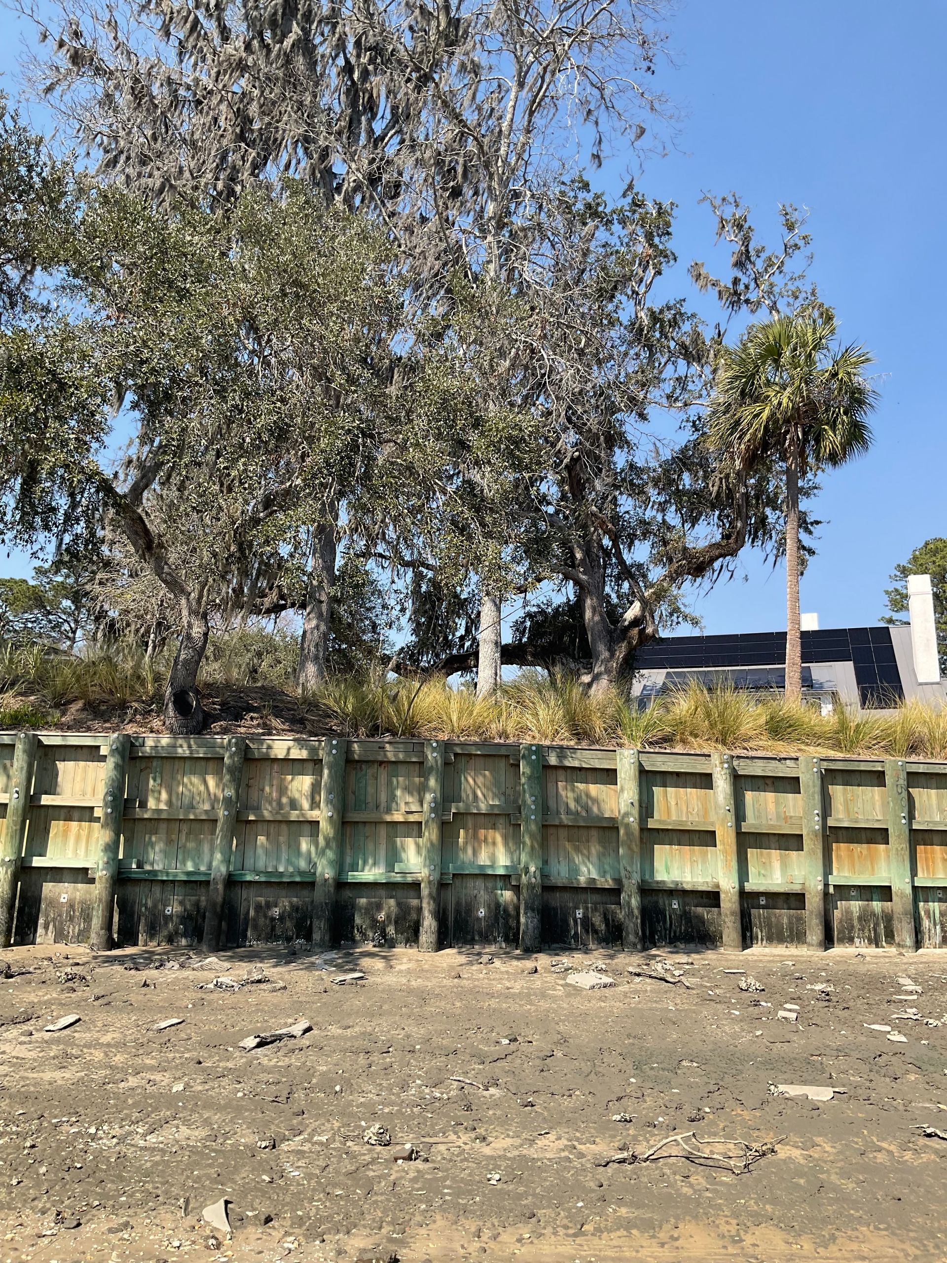 A wooden fence with a tree in the background