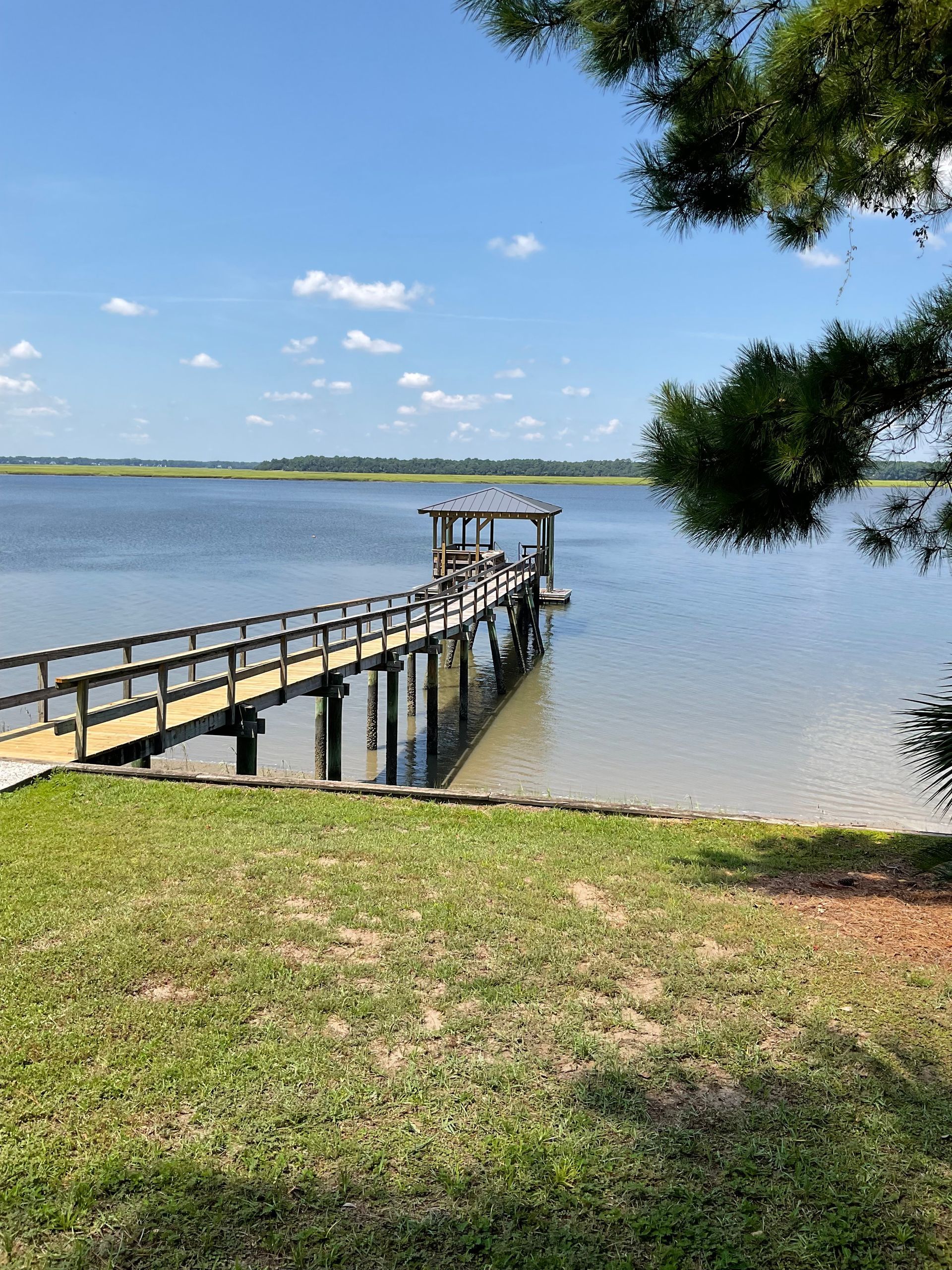 A dock overlooking a large body of water on a sunny day.
