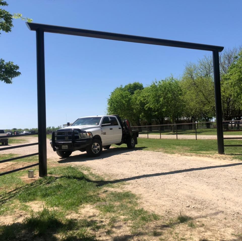A white truck is parked on a dirt road