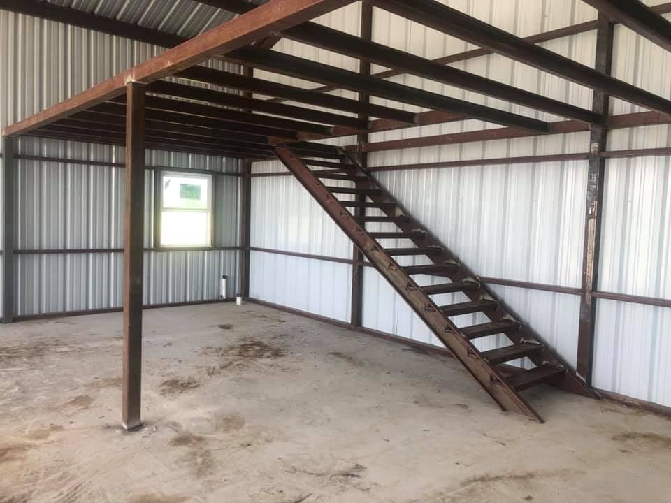An empty building with a staircase leading up to the second floor.