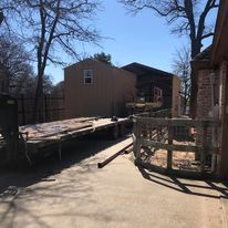 A shed is being built in the backyard of a house.