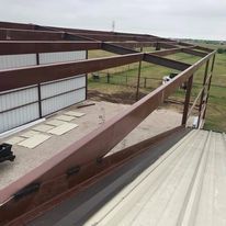A large metal structure is being built on top of a building.