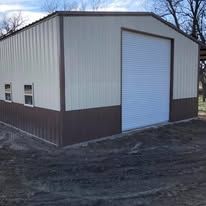 A white and brown metal building with a white garage door.