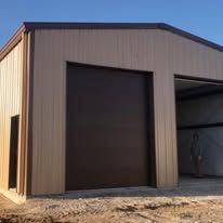 A large metal building with a large garage door.