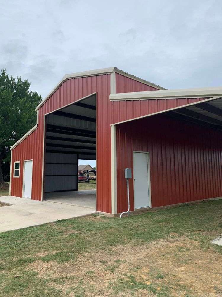 A red barn with the doors open and a white roof