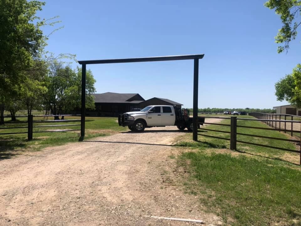 A white truck is parked in the middle of a dirt road.