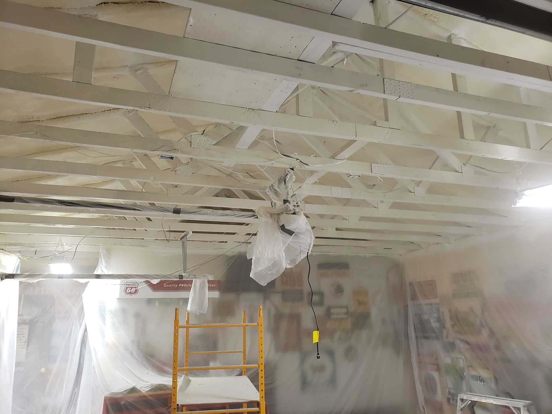 The ceiling of a building is being sprayed with foam.