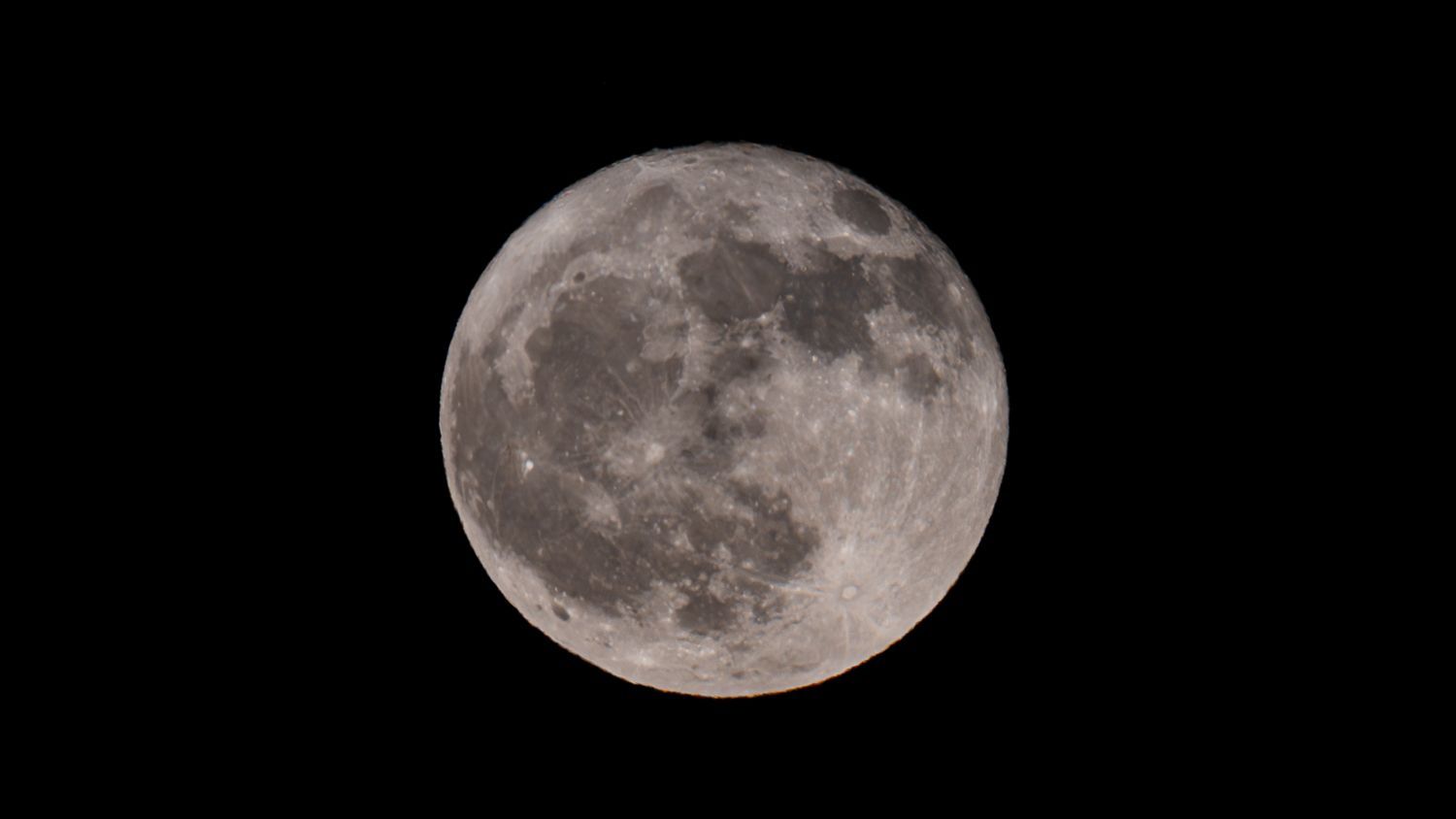 A full moon is visible in the night sky.