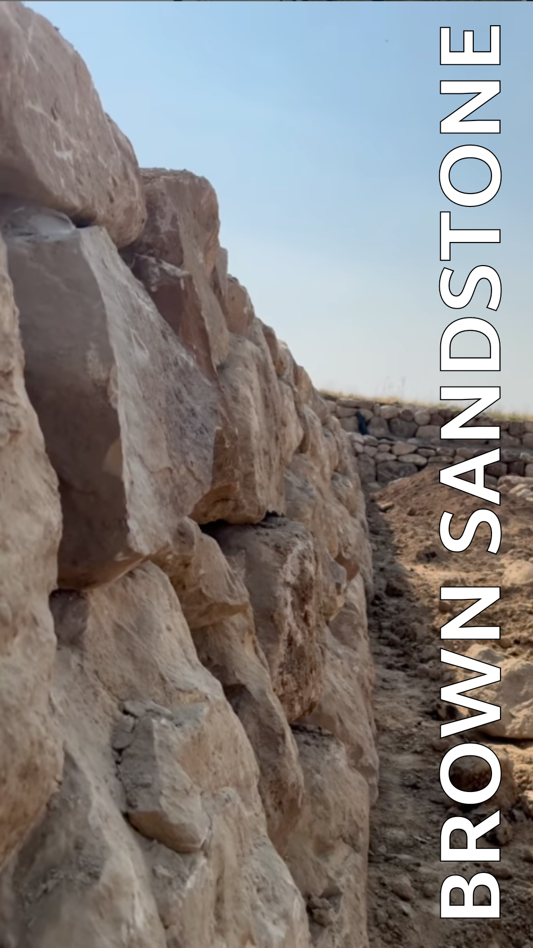 A large rock wall with the words `` brown sandstone '' written on it.