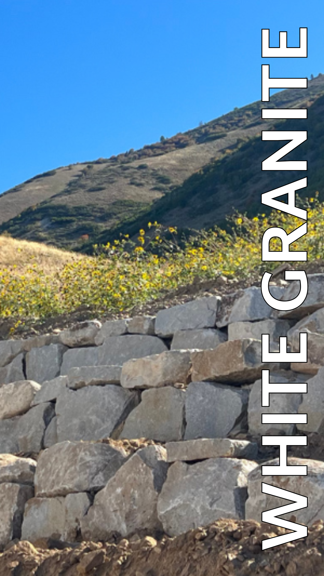 A white granite wall with a mountain in the background