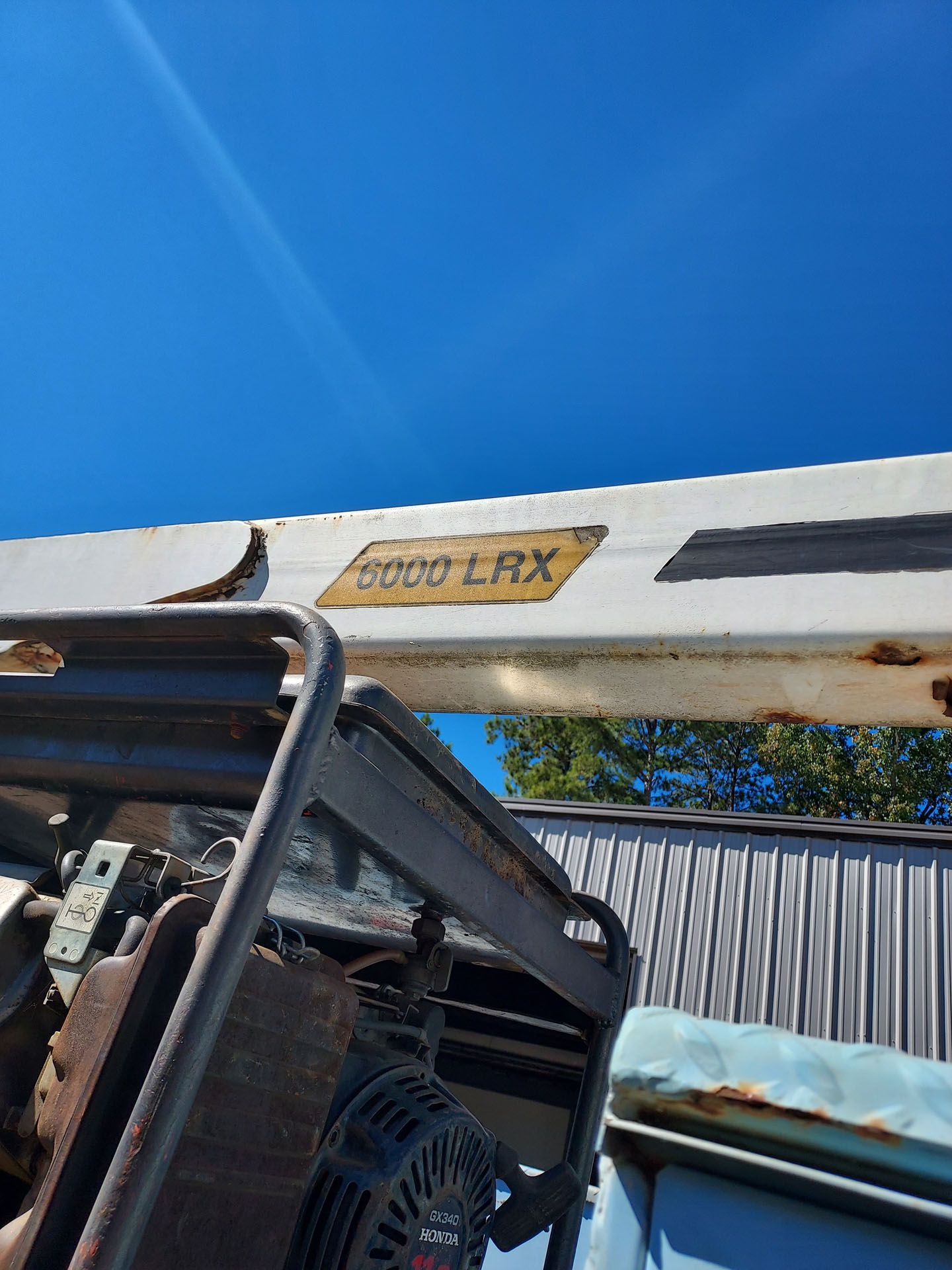 A white truck with the word lrx on it is parked in front of a building.