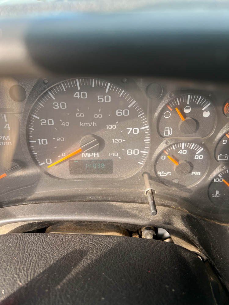 A close up of a dashboard of a car showing the speedometer at 70
