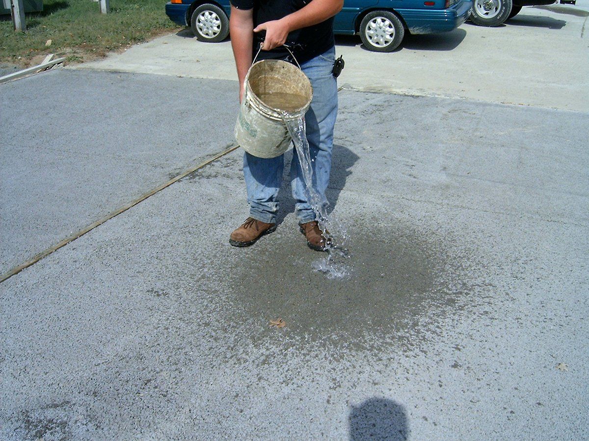 Worker Pouring Water On The Concrete — Westminster, MD — Thomas, Bennett & Hunter, Inc.
