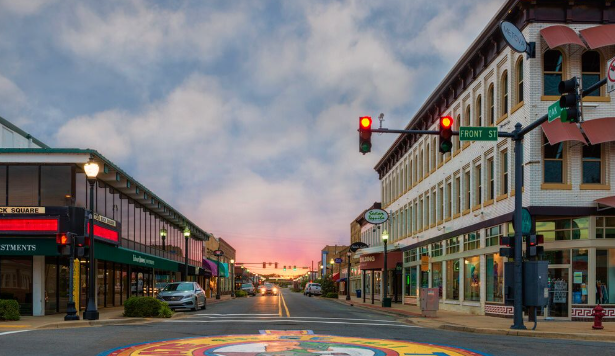 A city street with a painting on the side of the road.