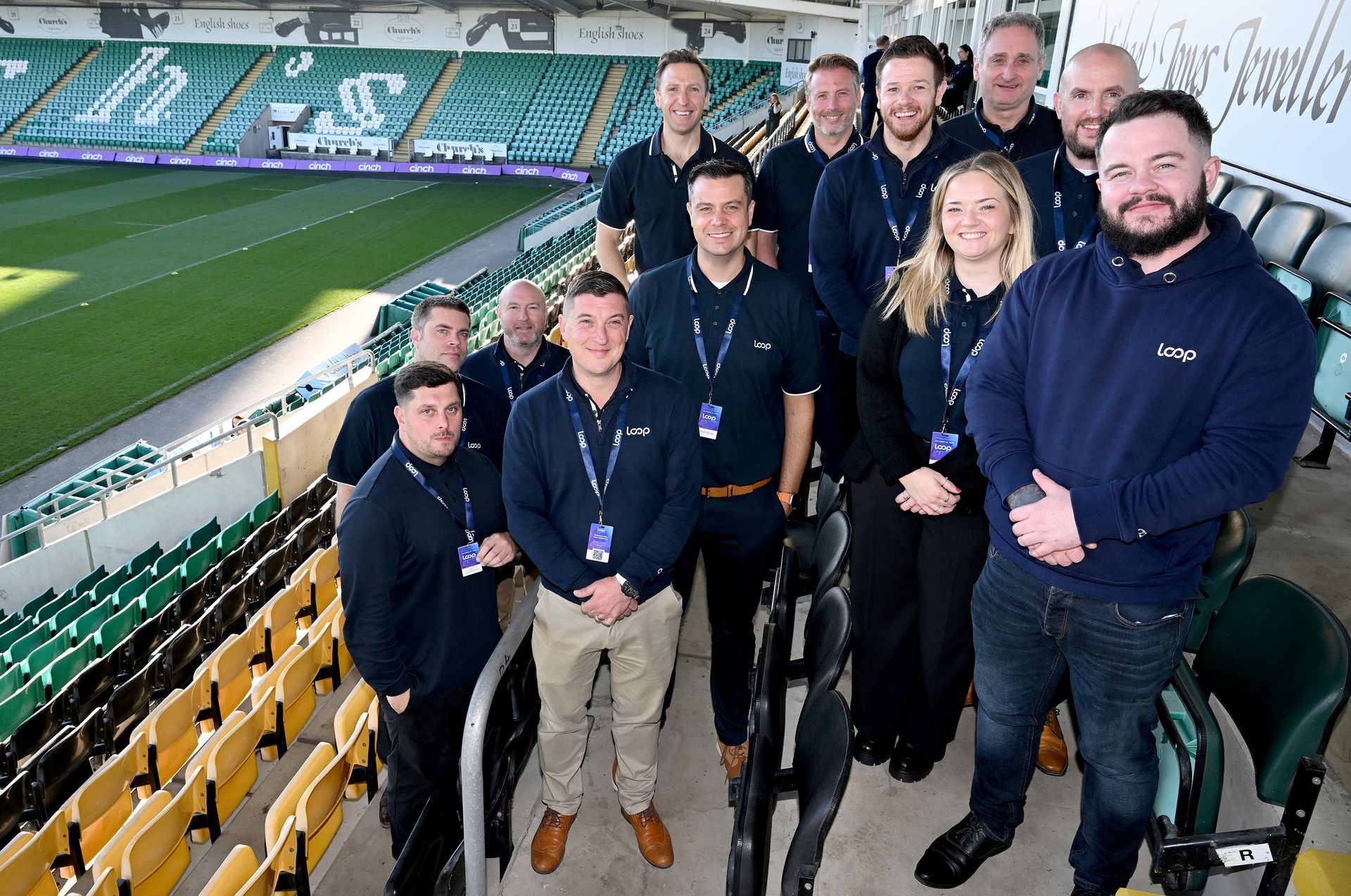 A group of men are sitting on a couch and a man is giving a presentation.