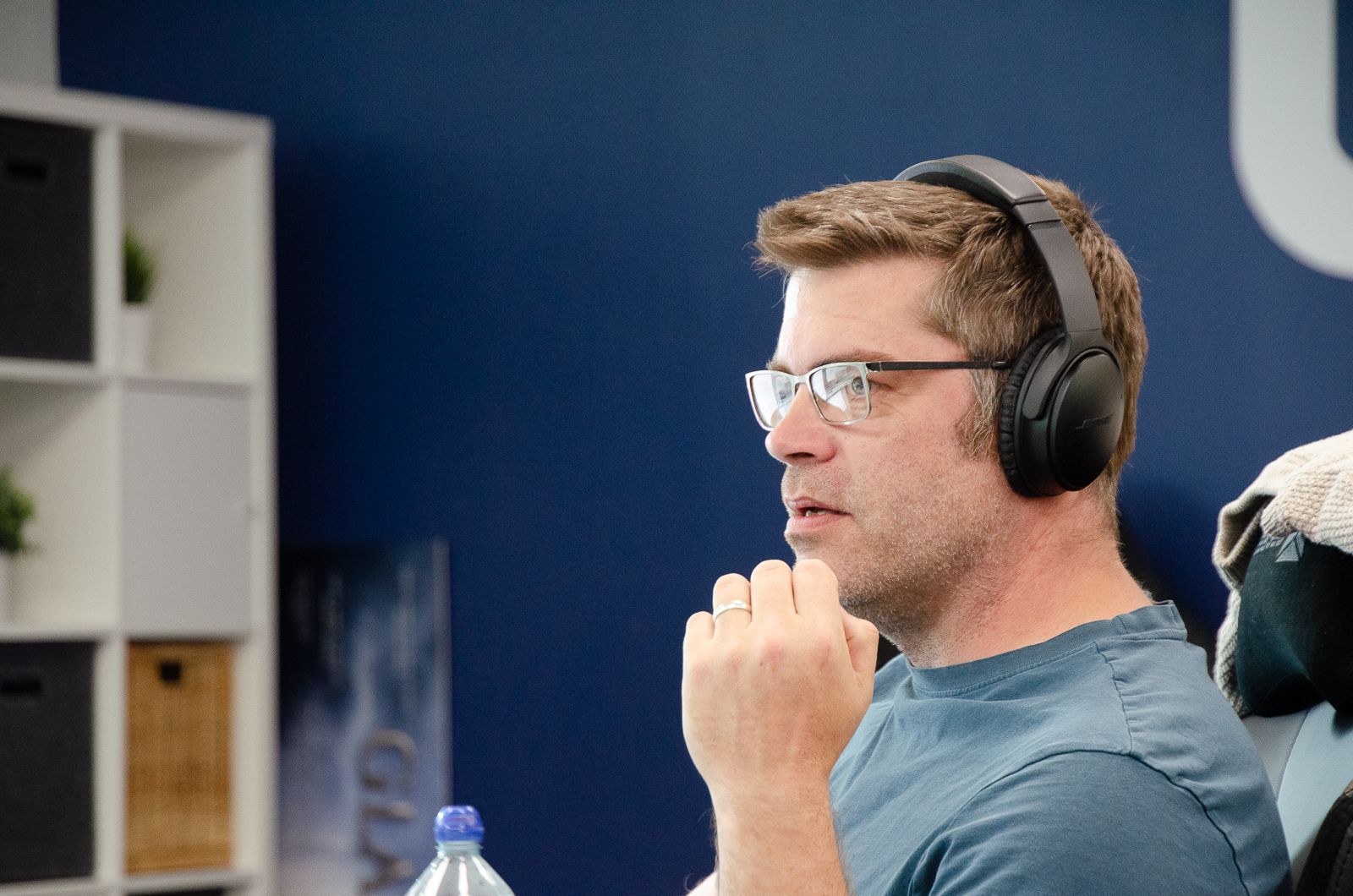 A man with a beard is smiling for the camera in an office.