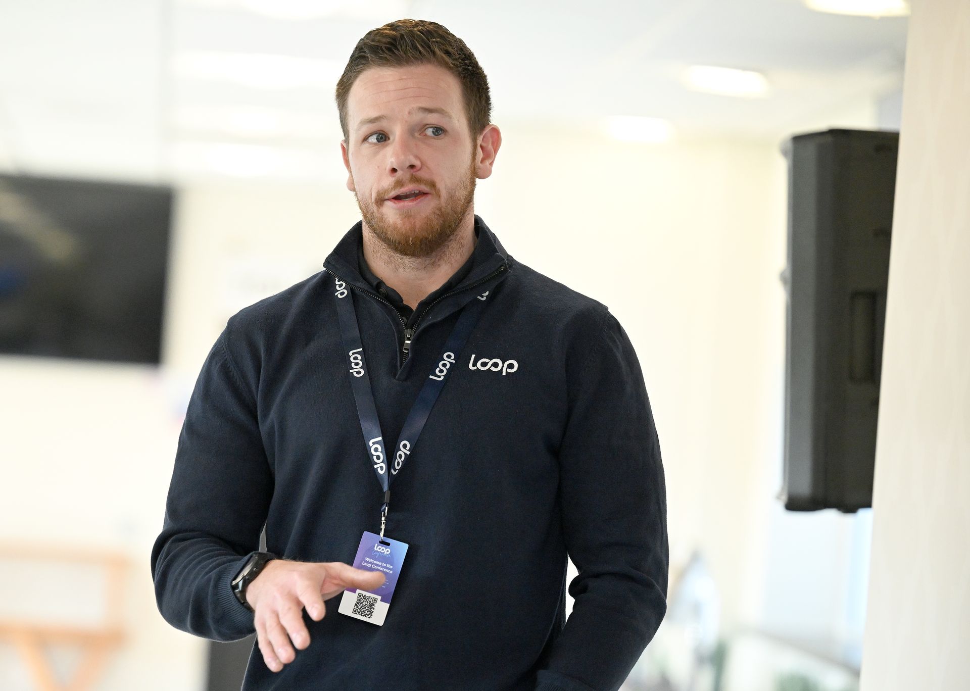 A man wearing headphones is writing on a whiteboard.