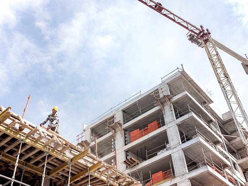 A building is being built with a crane in the background.