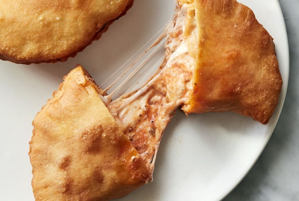 A close up of a plate of food with a bite taken out of it.