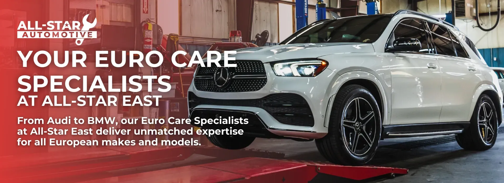 A group of people standing in front of a red car on a lift | All-Star Automotive