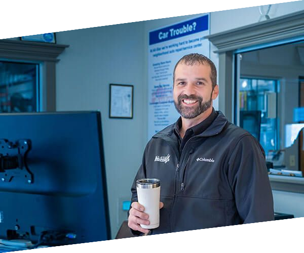 Staff member holding a cup of coffee | All-Star Automotive