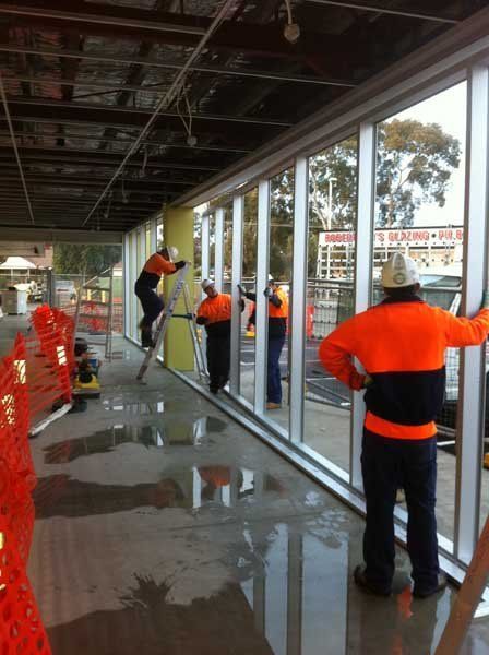 workers installing floor to ceiling windows